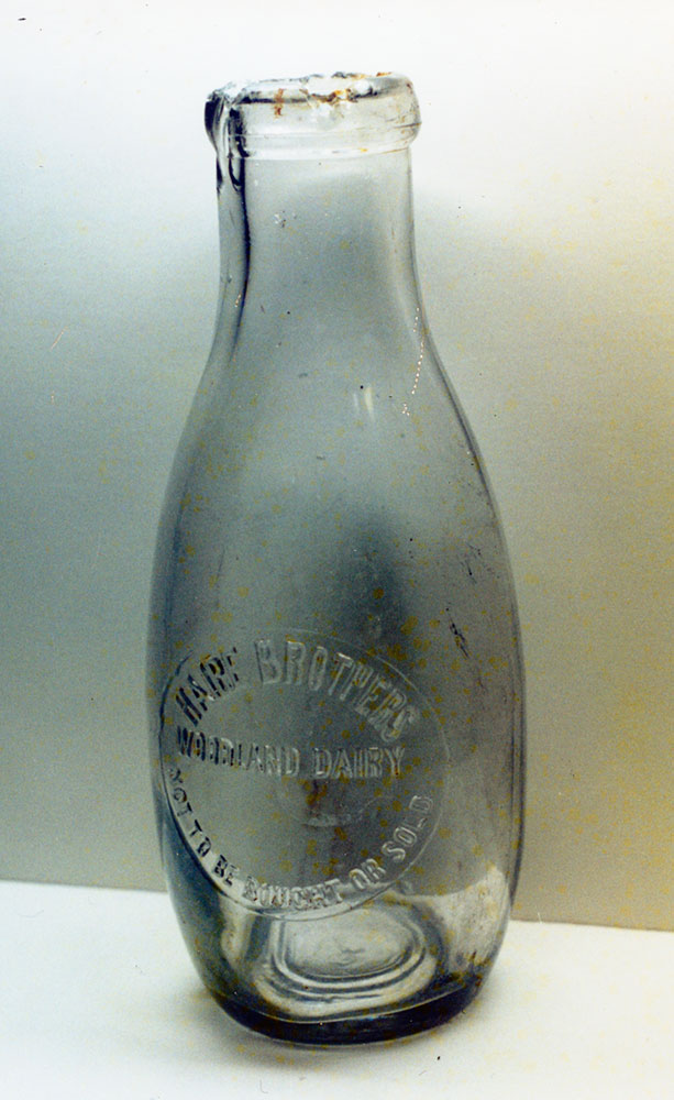 Very early, very rare Haire Brothers Woodland Dairy Empire style (Bowling Pin) Quart embossed milk bottle.